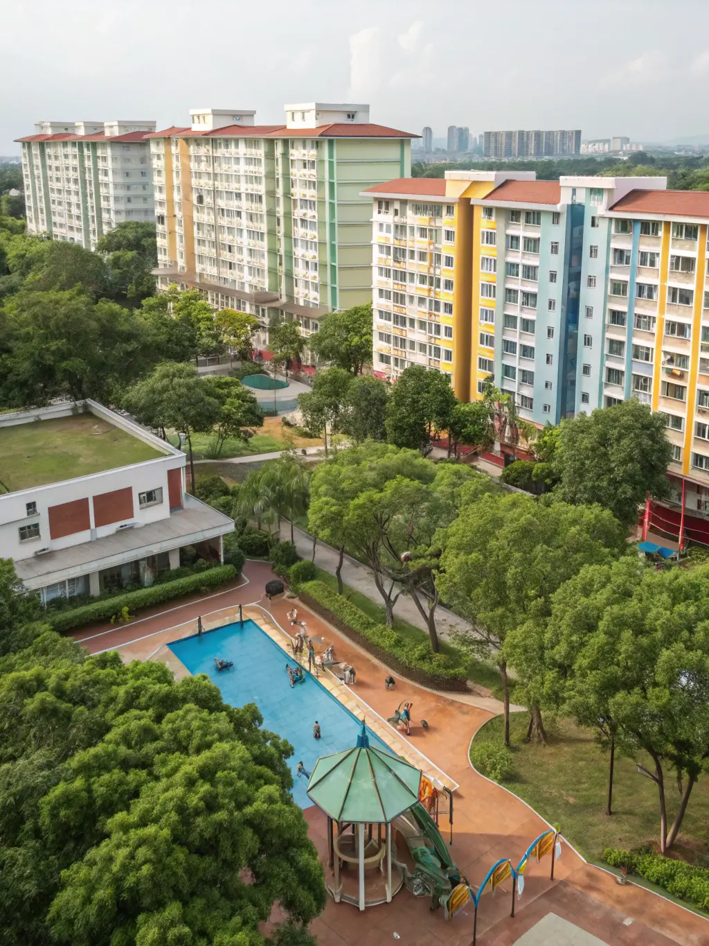 A spacious family home with a lush green lawn and a white picket fence in a suburban Singapore neighborhood.